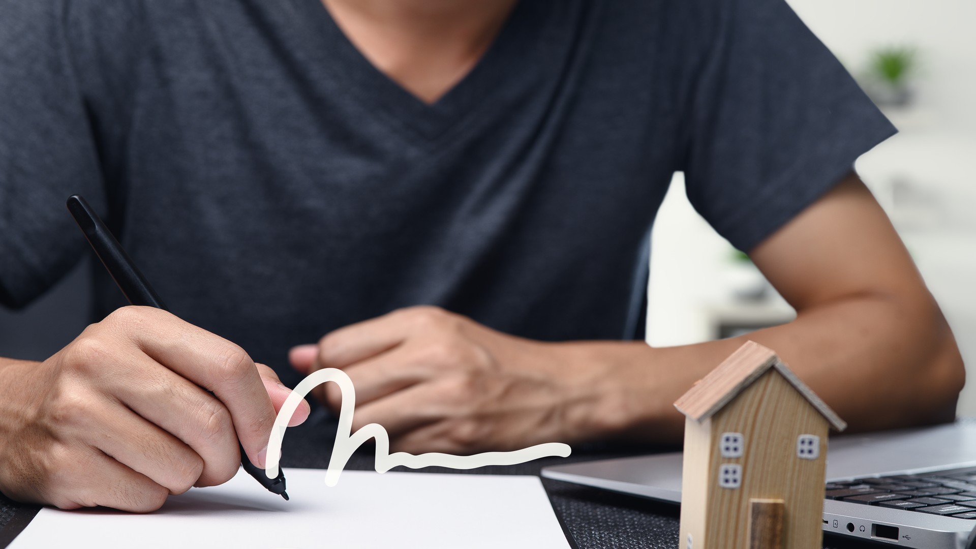 Borrower at kitchen table reviewing a mortgage preapproval letter and budget worksheet